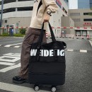 Expandable wheeled travel bag with retractable handle