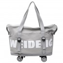 Expandable wheeled travel bag with retractable handle