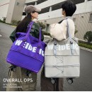 Expandable wheeled travel bag with retractable handle